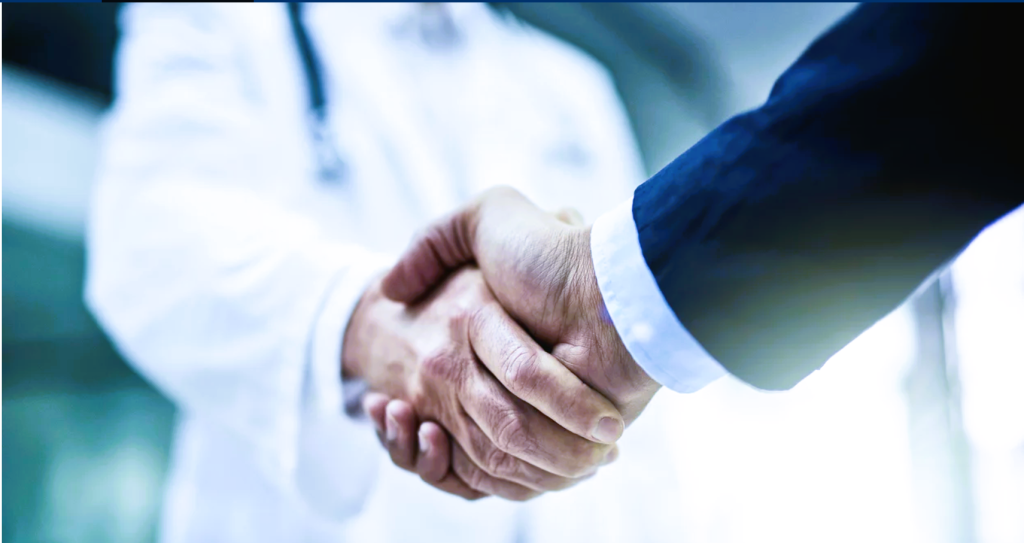 Inflection 360 doctor and business professional shaking hands during a healthcare acquisition meeting.